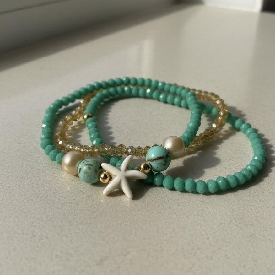 Turquoise beaded bracelet with starfish charm on a light surface