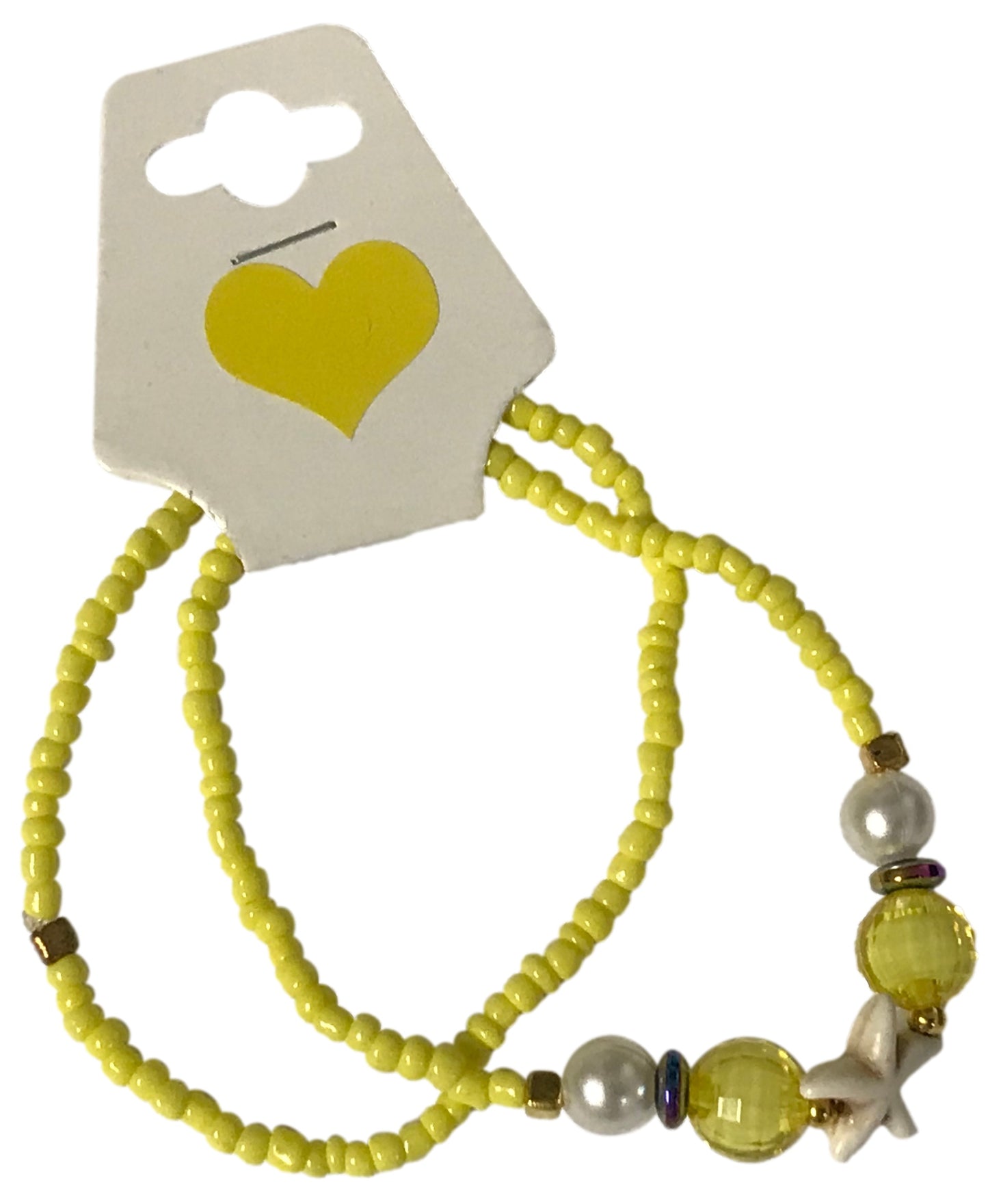 Yellow beaded bracelet with decorative elements on a card with a heart symbol