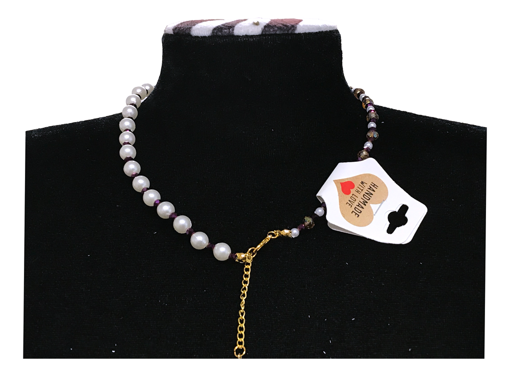 Necklace with a heart-shaped tag on a black stand