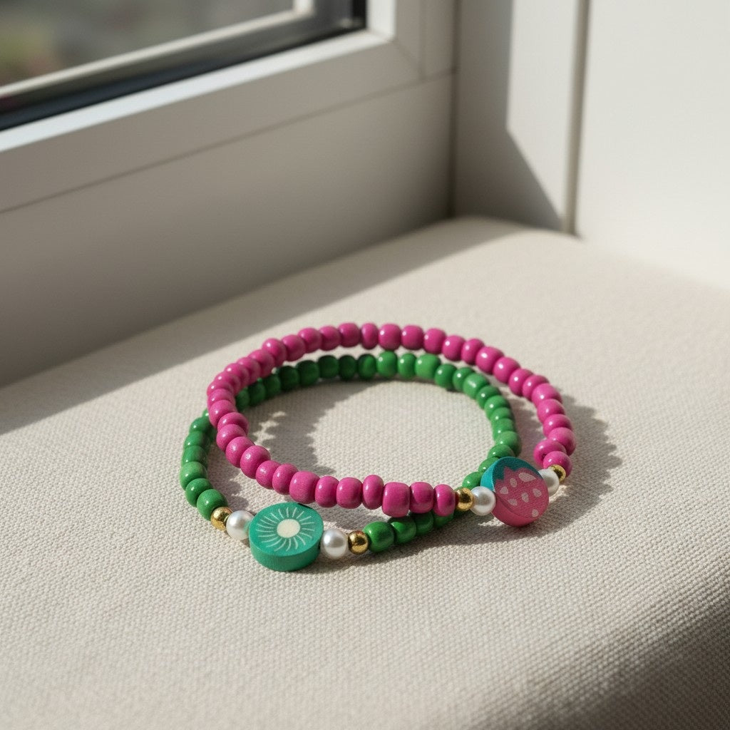 Two colorful beaded bracelets on a light surface with a window in the background