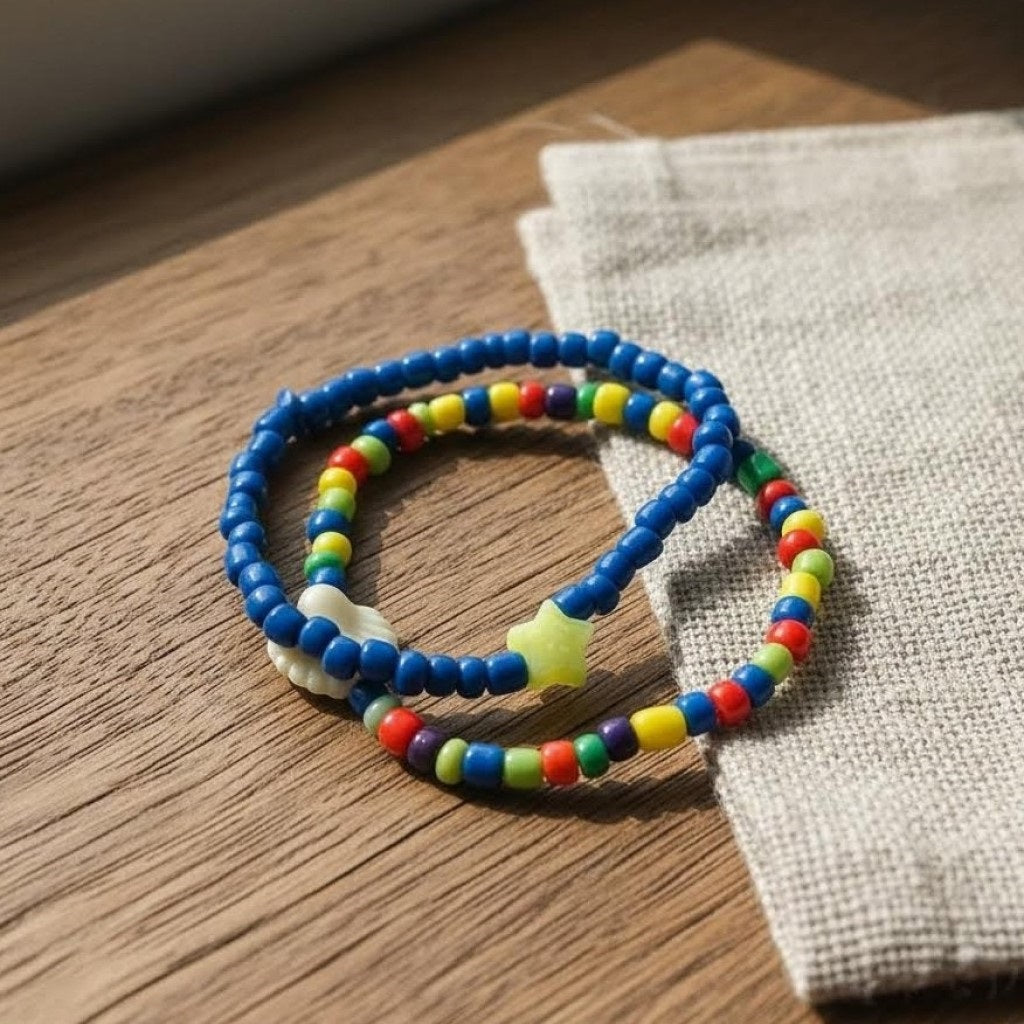 Colorful beaded bracelets on a wooden surface with a fabric background