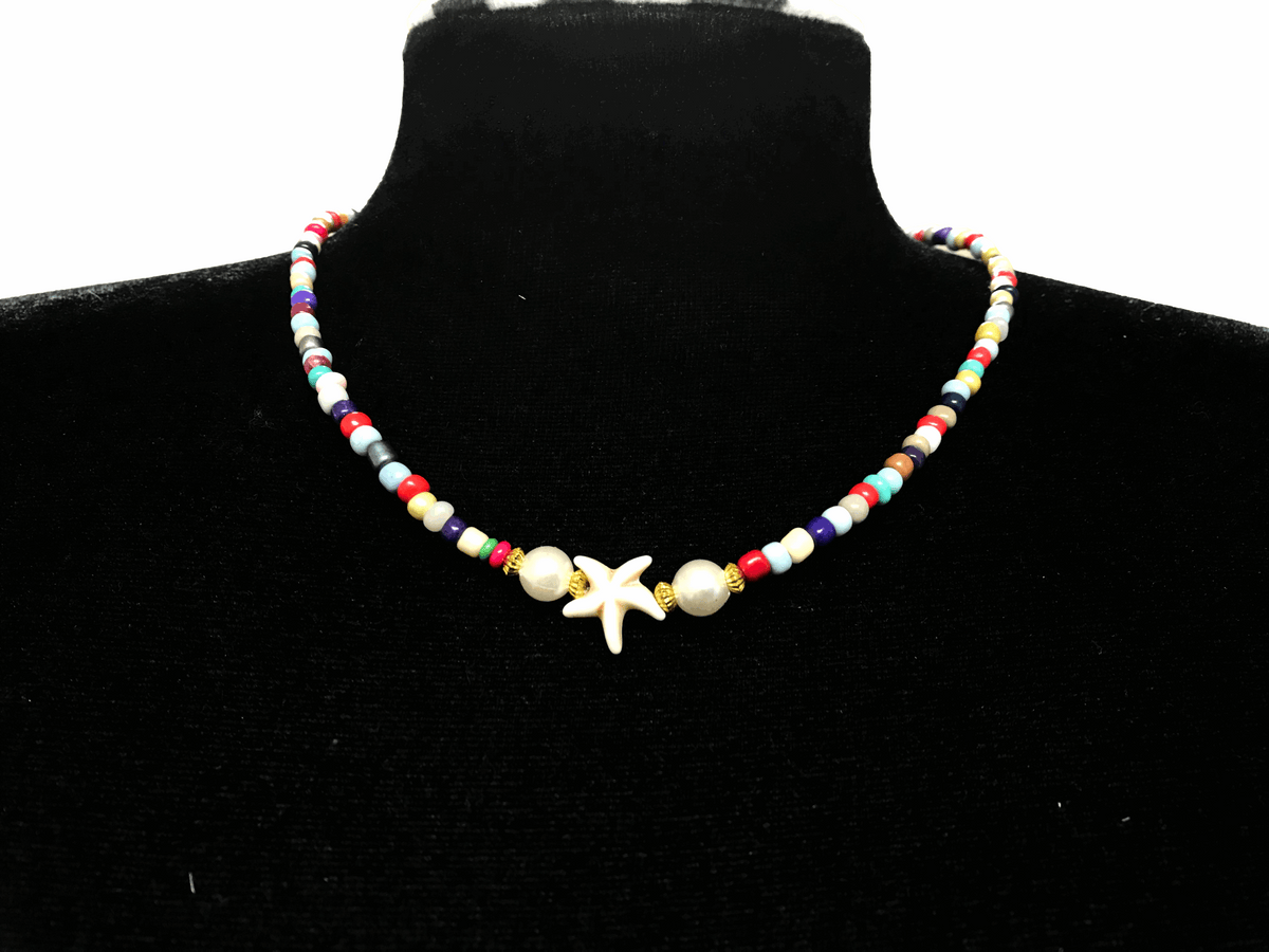 Colorful beaded necklace with a starfish pendant on a black mannequin.