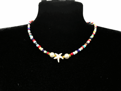 Colorful beaded necklace with a starfish pendant on a black mannequin.