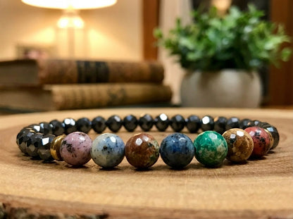 Multicolored beaded bracelet on a wooden surface with a blurred indoor background