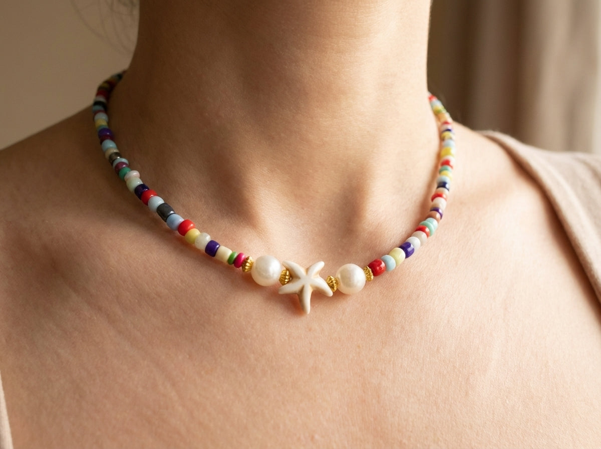 Colorful beaded necklace with a starfish charm worn by a woman