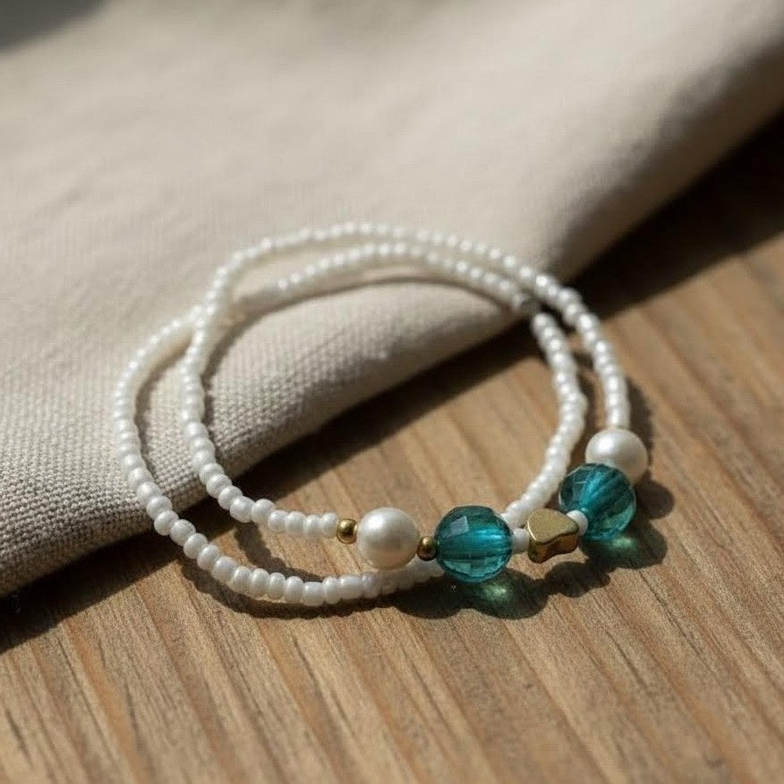 Pearl bracelet with blue beads on a wooden surface