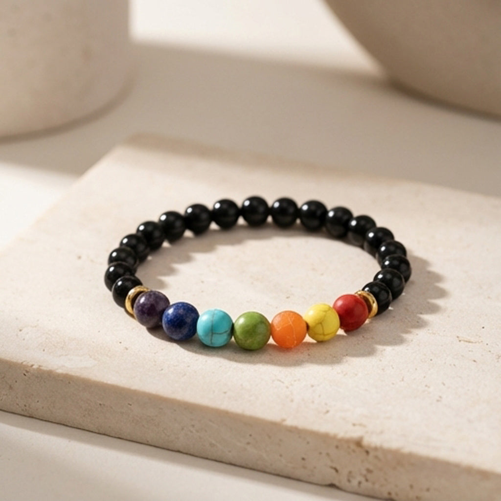 Black beaded bracelet with colorful beads on a light surface