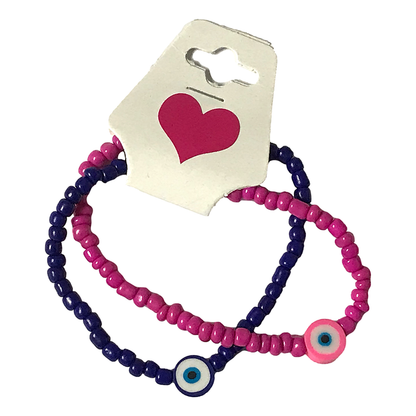 Two pink and purple beaded bracelets with evil eye charms on a white background