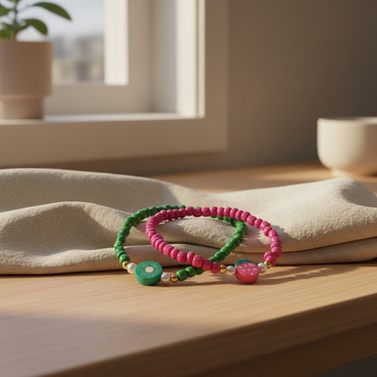 Two colorful beaded bracelets on a wooden surface with a soft, natural light background.