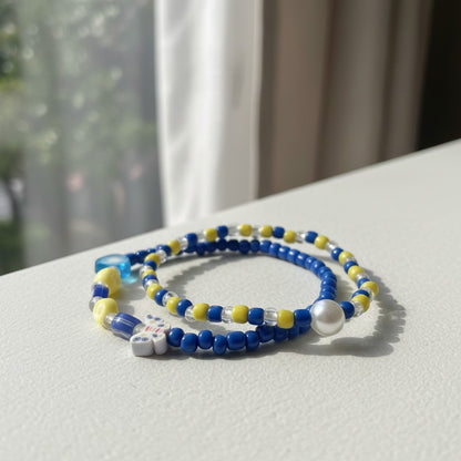 Two beaded bracelets on a light surface with a blurred background