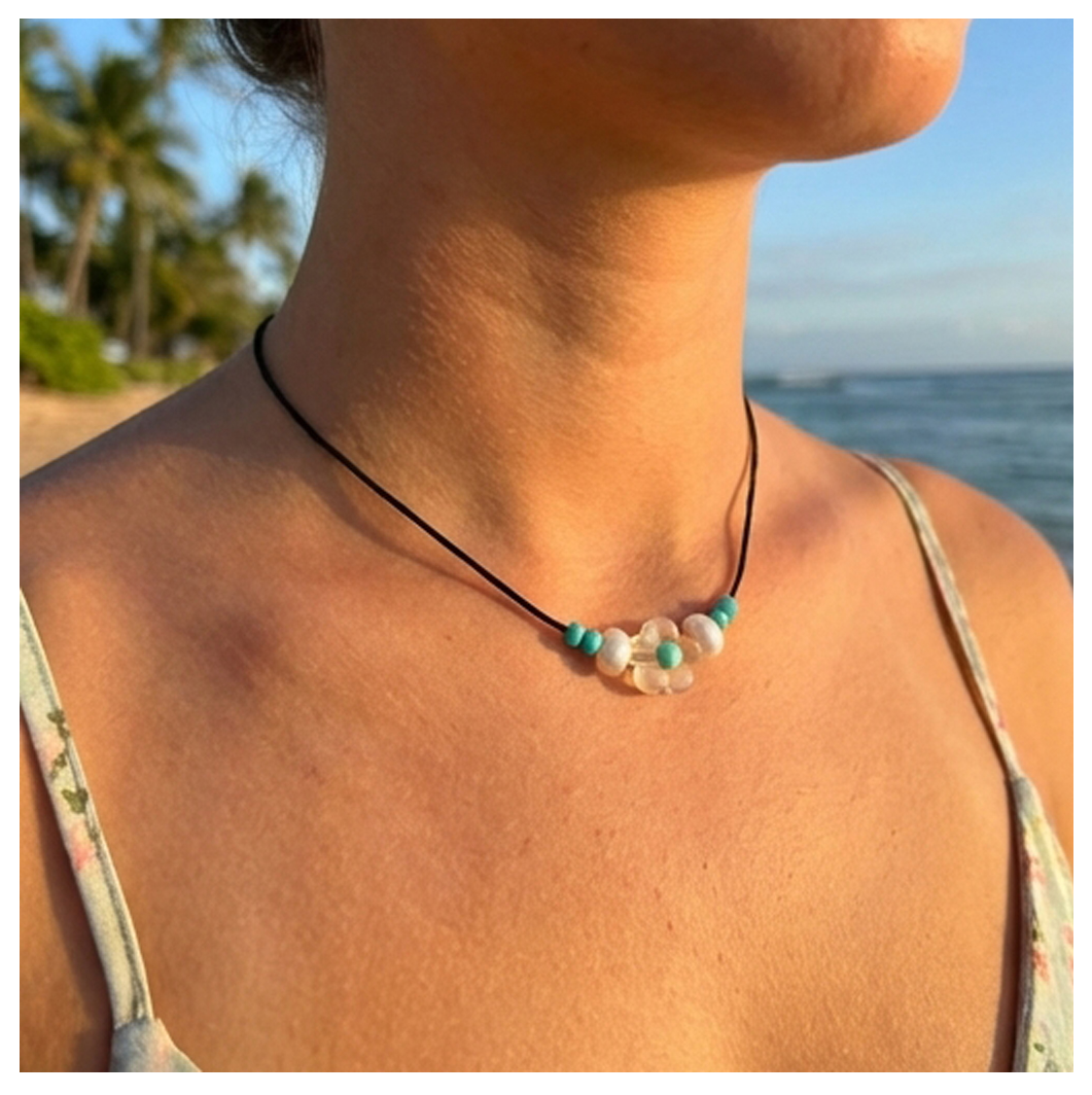 Necklace with beads worn by a person at a beach