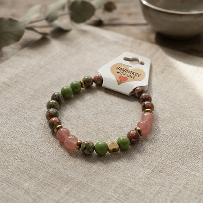 Beaded bracelet with a 'Handmade with Love' tag on a textured surface