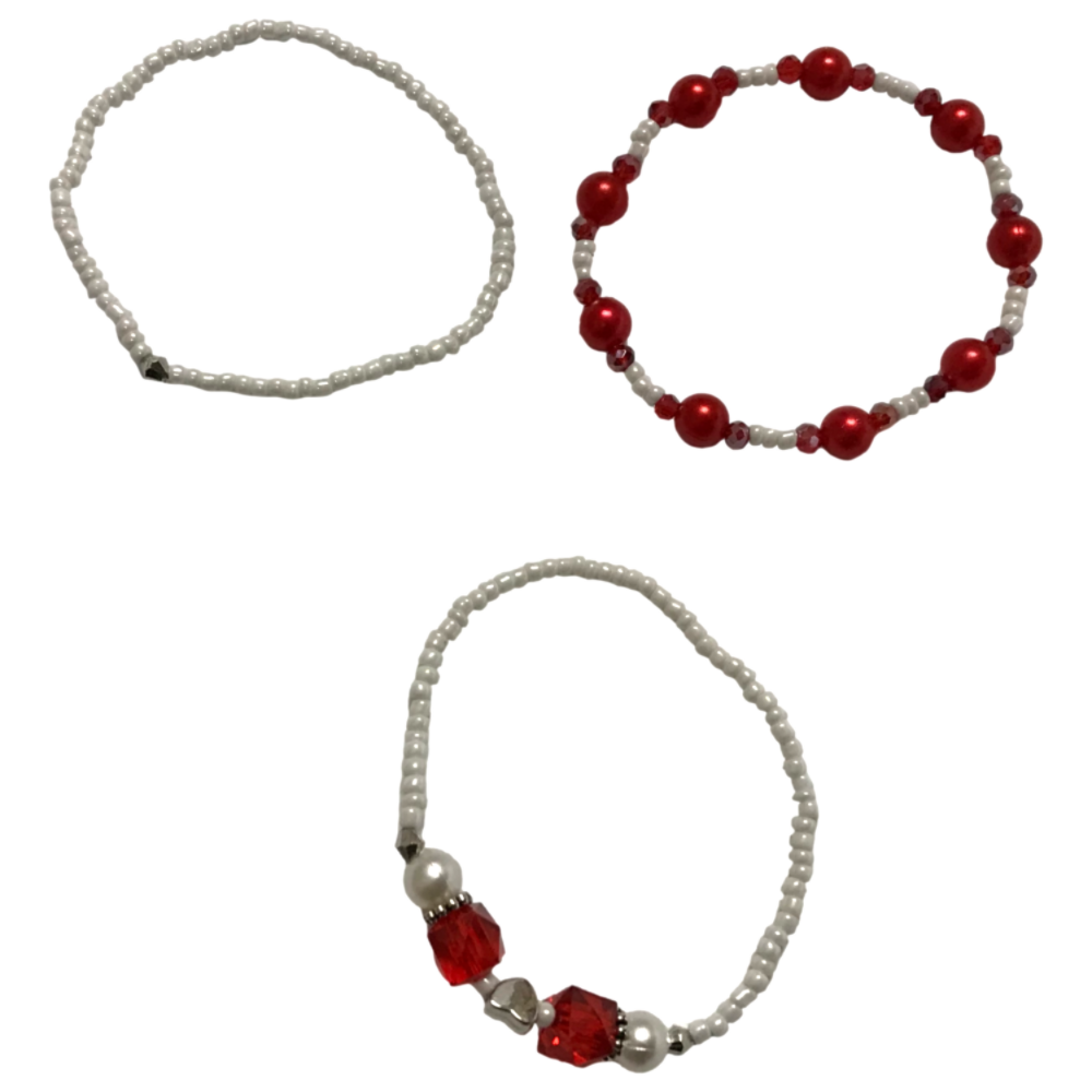 Three beaded bracelets with red and white beads on a white background