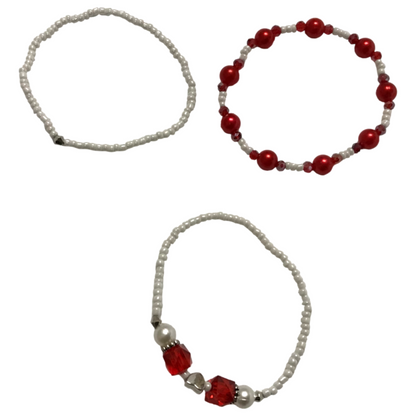 Three beaded bracelets with red and white beads on a white background