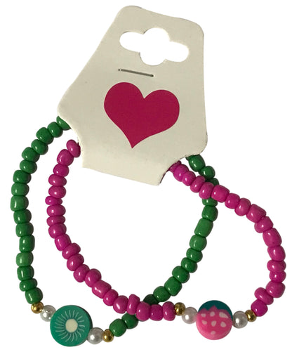 Two green and pink beaded hair ties on a card with a heart design.