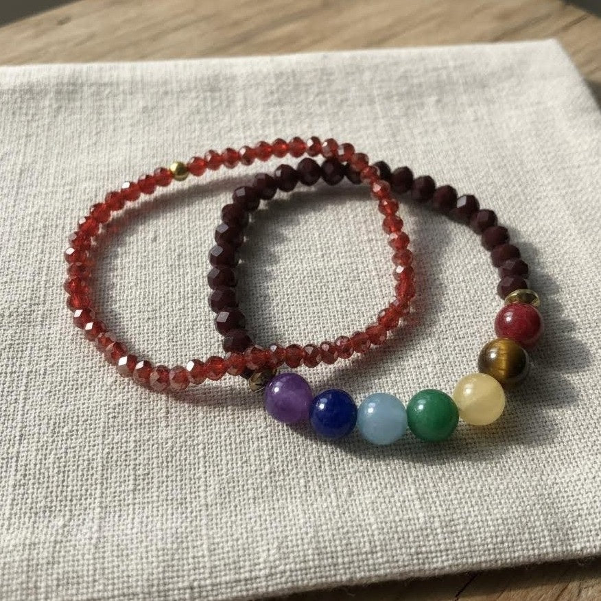 Set of beaded bracelets with colored beads on a textured fabric surface