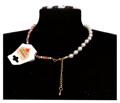 Pearl necklace with a heart-shaped tag on a black stand