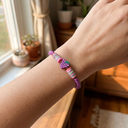 Colorful beaded bracelet on a wrist with a home interior background
