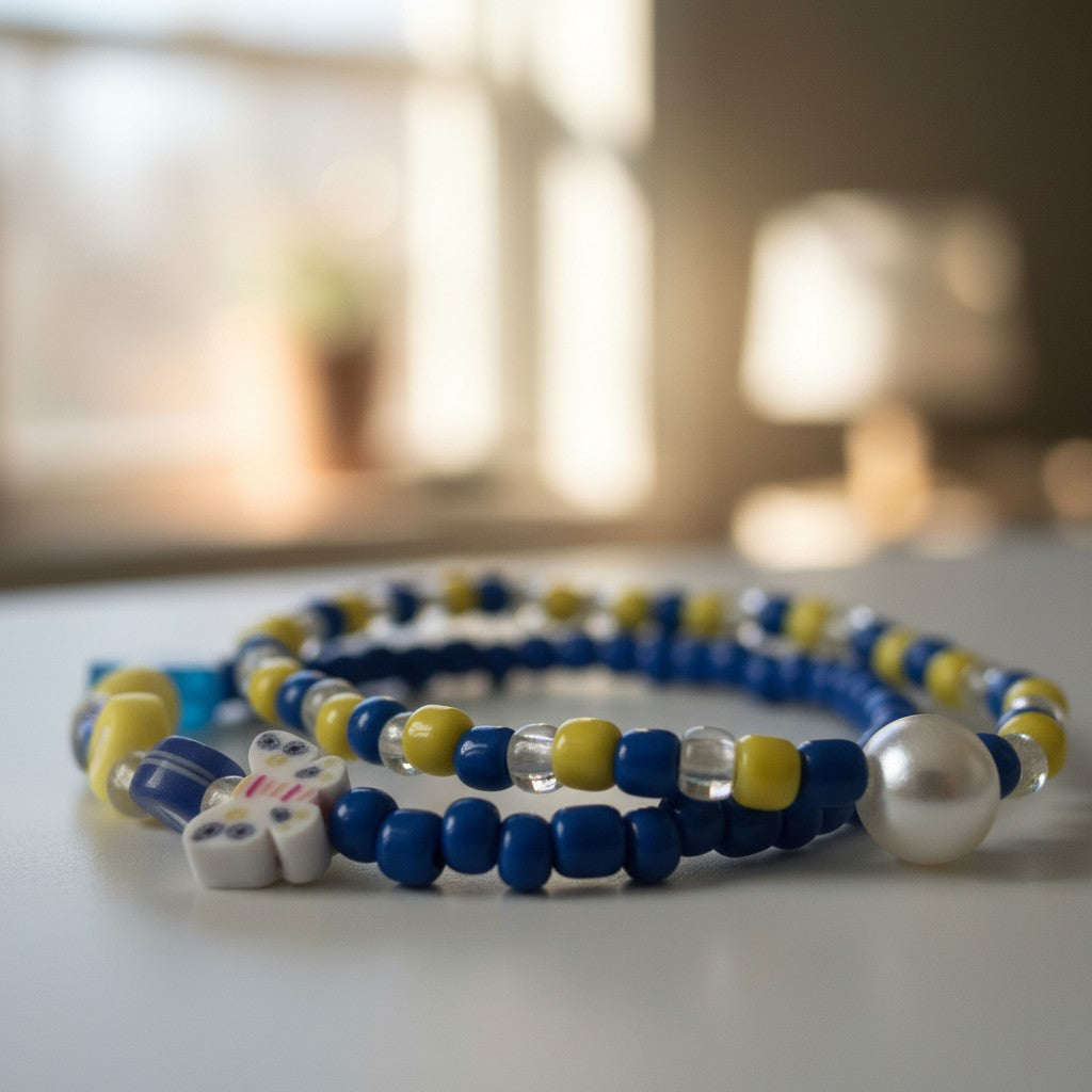 Beaded bracelets with blue, yellow, and clear beads on a blurred background