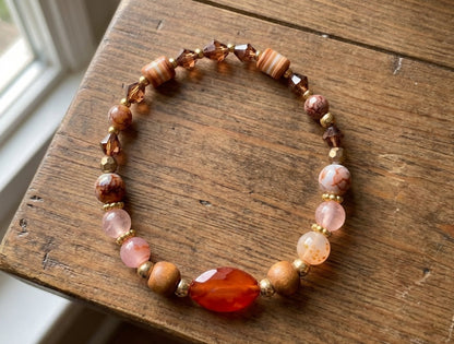 Handmade Beaded Bracelet with Warm Brown, Pink & Red Tones and Red Gemstone-Style Centerpiece – Earthy Autumn Jewelry