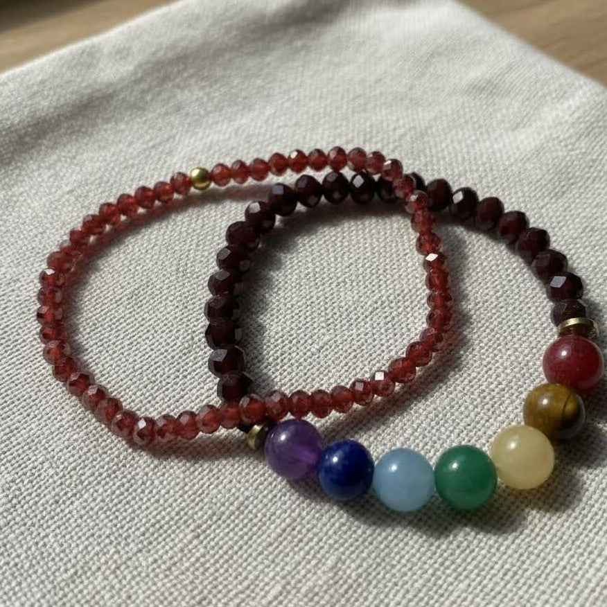 Two beaded bracelets on a light fabric background
