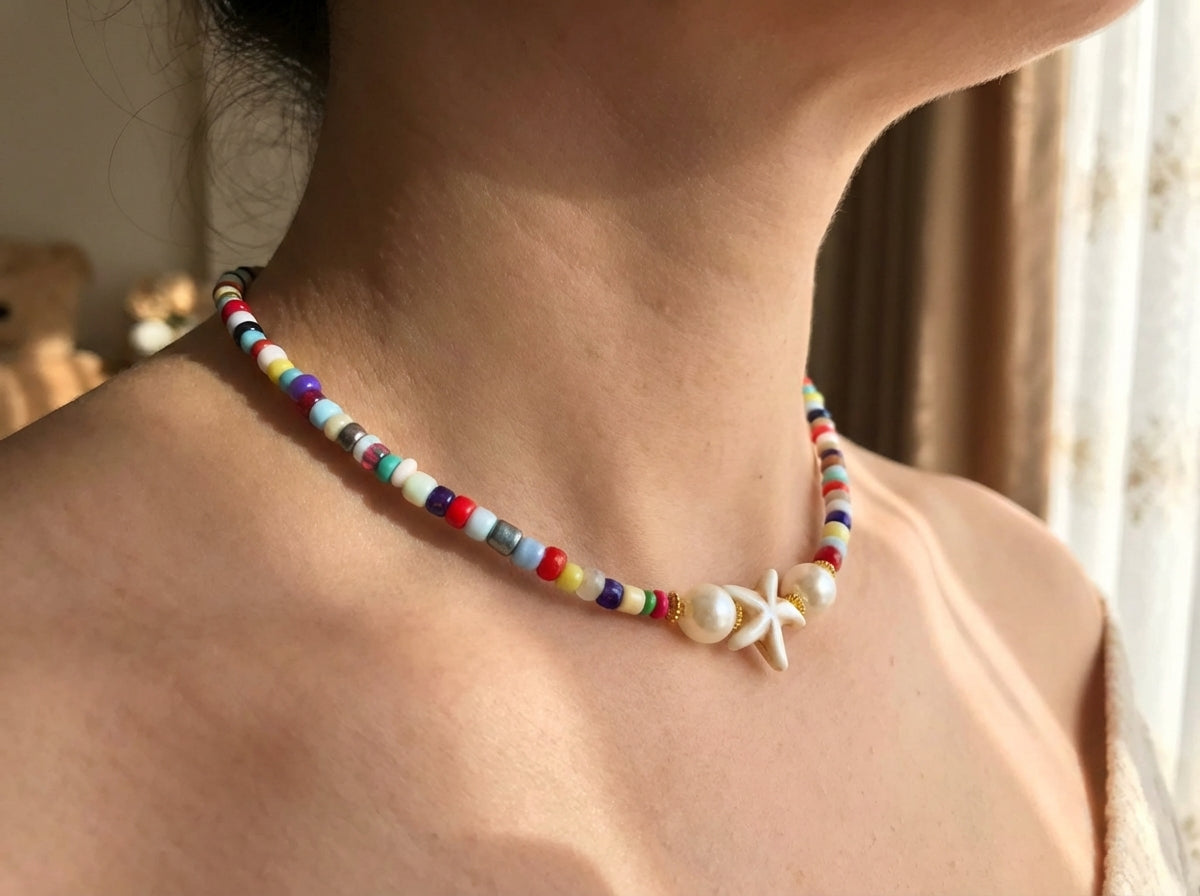 Colorful beaded necklace with pearls and starfish charm worn by a woman