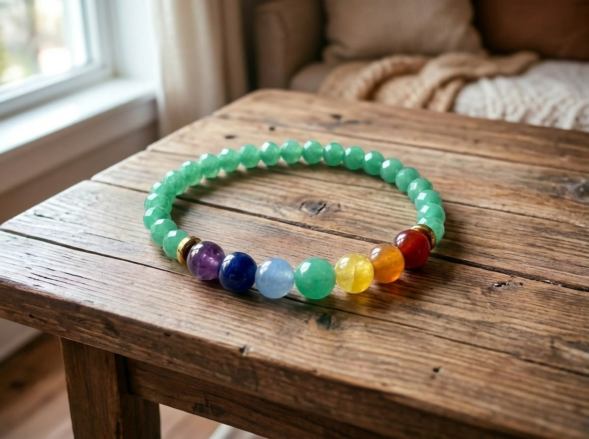 Green and colorful beaded necklace on a wooden table with a blurred indoor background