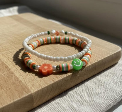 Handmade 2-Piece Bracelet Set with White Beads, Orange & Green Accents, Flower & Smiley Charms – Gift Jewelry, Boho Chic Style
